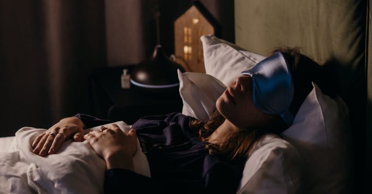 A woman resting with a sleep mask in a calm bedroom setting, creating a serene and cozy atmosphere.