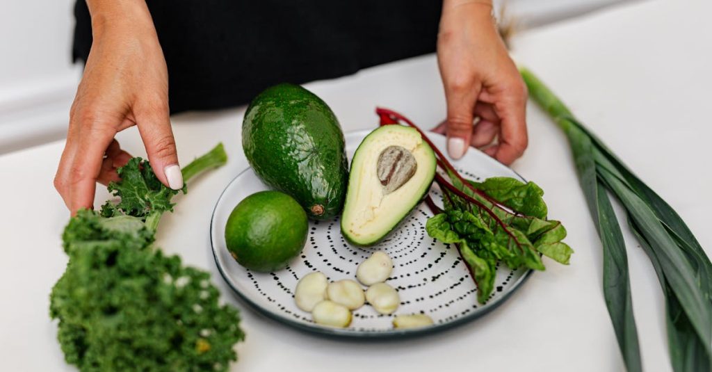 Top view of assorted fresh ingredients including avocado and kale on a plate. Perfect for healthy eating themes.