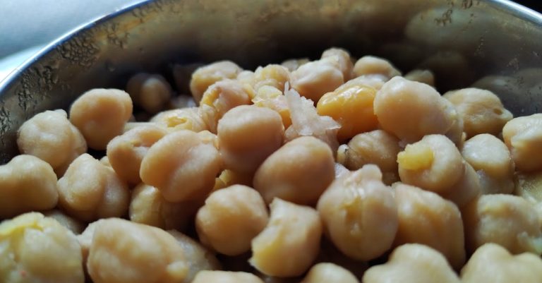 High angle view of cooked chickpeas in a metal bowl, showcasing a healthy vegan food option.