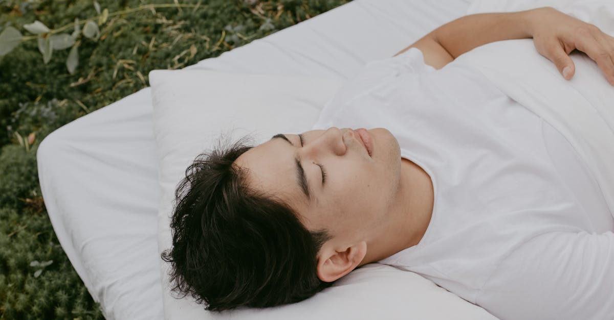 A peaceful moment of an adult resting outdoors on a pillow, embodying tranquility and comfort.